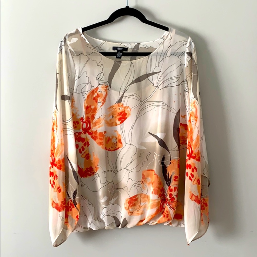 Great loose fitting blouse with sheer sleeves.